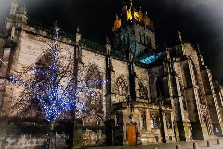 Ein großes Steinkirchengebäude, nachts hell erleuchtet.