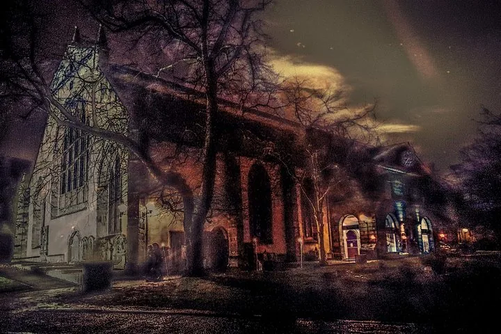 An atmospheric night view of Greyfriars Kirk with dramatic lighting.